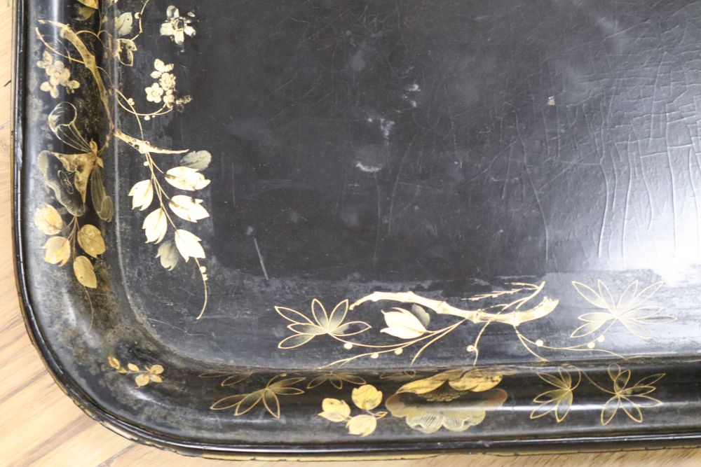 A large papier mache gilt-decorated tray and a 1930s carved oak Canterbury, with double rattan sides